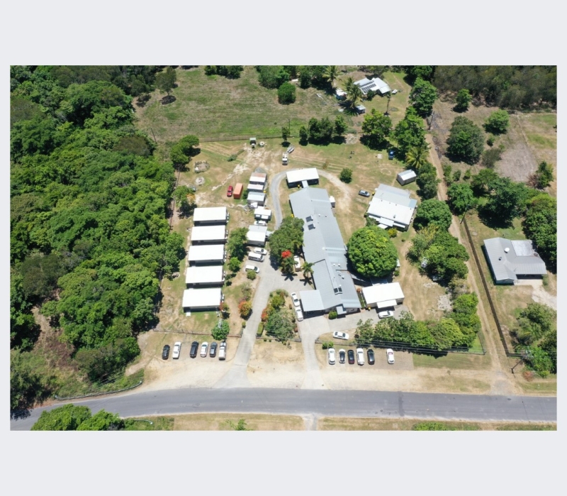 An aerial view of a large building surrounded by smaller buildings