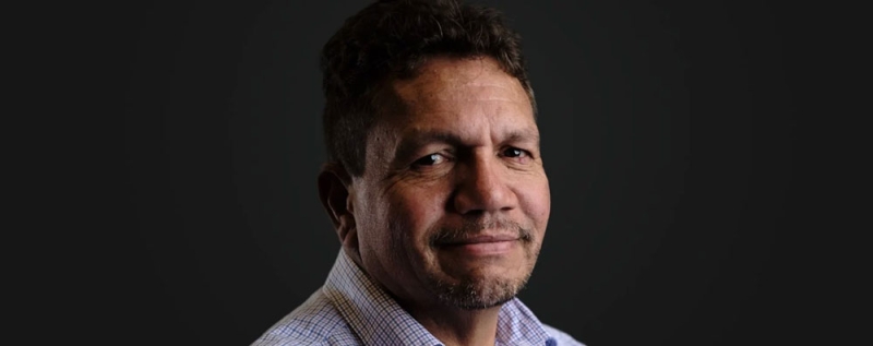 A close up of a man smiling at the camera