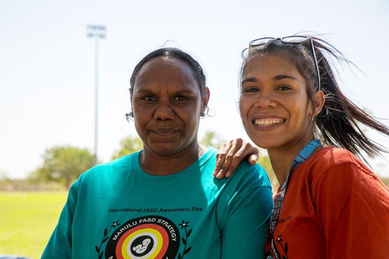 Two women smile at the camera