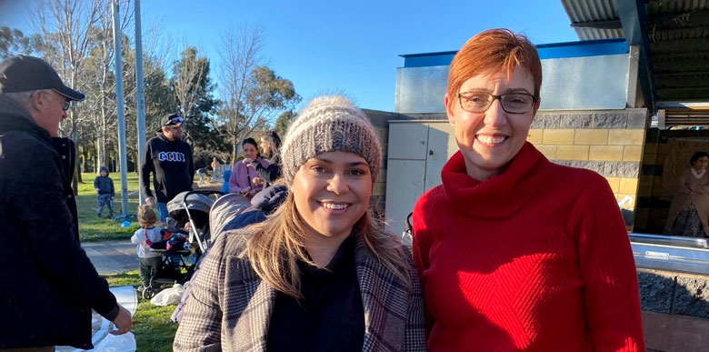 Two women smile at the camera