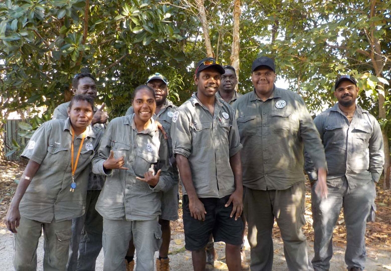 A group of people smiles at the camera