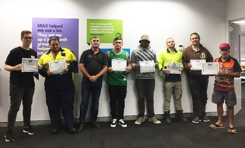 A group of people hold up certificates