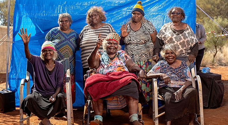 A group of women pose outdoors