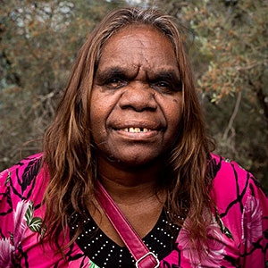 A woman smiles at the camera