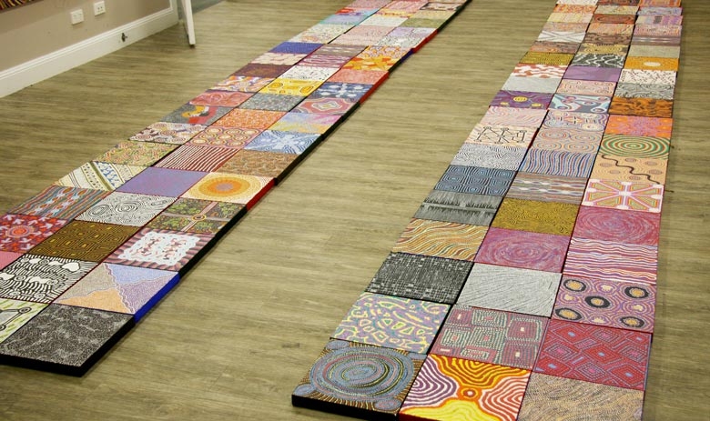Two long rows of small square artworks in columns of 3