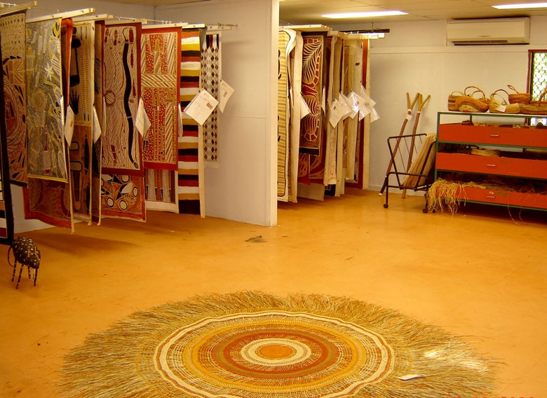 A number of mats hanging up in a showroom