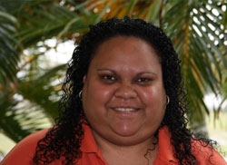 A woman smiles at the camera