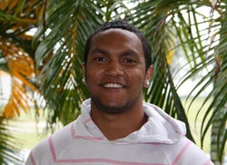 A man smiles at the camera