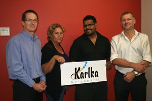 Four people hold up a sign saying Karlka