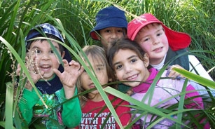 A group of children playing in long grass