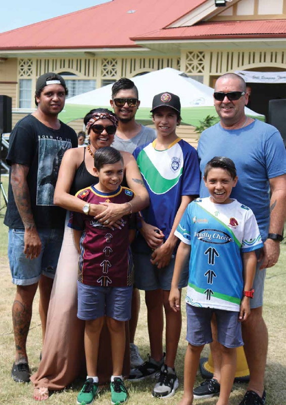 Several people of various ages stand together