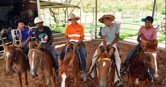 Five people sitting on horses