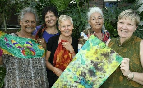 A group of 5 women smile at the camera.