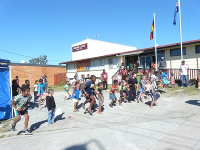 A group of children in a paved outdoor area