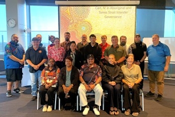 A group of people sitting and standing facing the camera