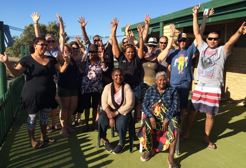 A group of people wave their hands in the air