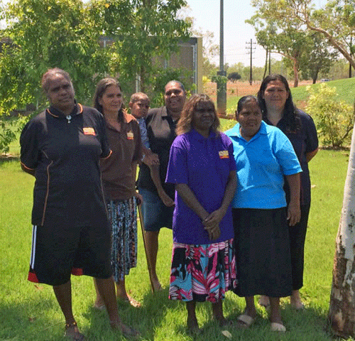 A group of women standing on grass