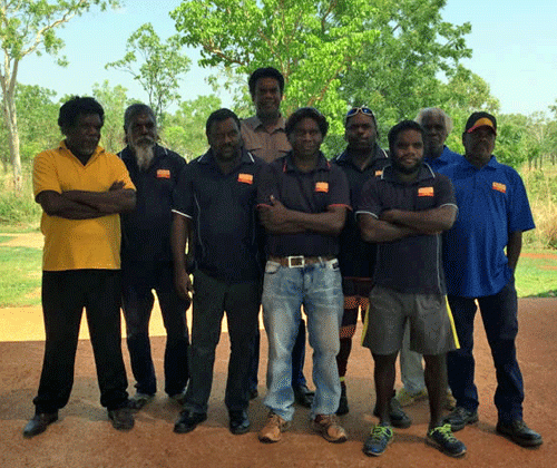 A group of men stand in an outdoor area