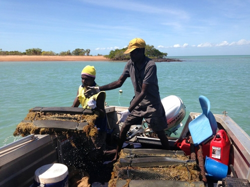 People on a boat handling equipment